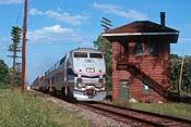 Amtrak's Sunset Limited heads west into the setting Florida sun, crossing the diamonds at Baldwin, FL. (253K)