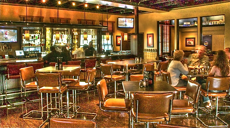 Streamliner Lounge bar and seating area with tables.