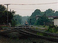 An eastbound Norfolk Southern train approaches the Alliance Amtrak platform on a rainy August afternoon.