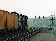 An eastbound empty stone train traverses the interlocking at Alliance.  It will stop, the power will run around the train and hook back on, and the train will proceed west on the Fort Wayne Line.