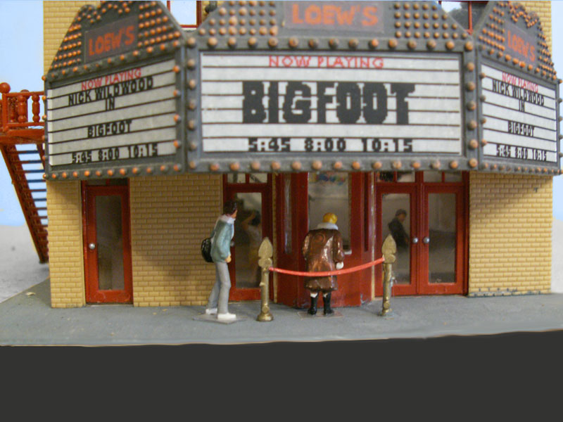 Buying movie tickets at the front window. Two tickets for Bigfoot please.