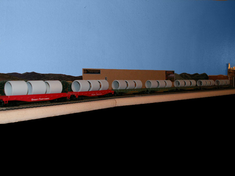 flat cars with cement pipe loads