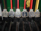 The right-hand end of the lever-frame showing the brass description plates for the Up line signals
