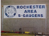 S gauge trains pass under the RASG banner at the RIT Model Railroad show, Henrietta, NY