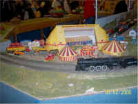 An American flyer 295 locomotive chugs past the circus.