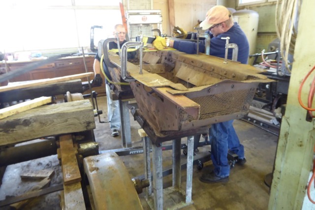 Removing the ash pan and transferring to the back room of the shop