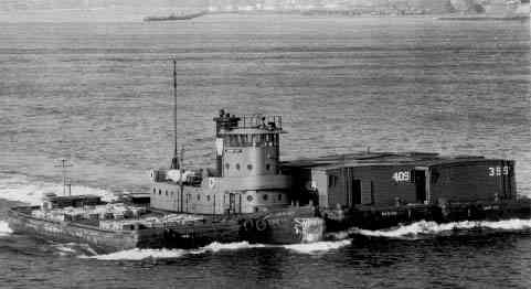 tug and barge with railroad cars