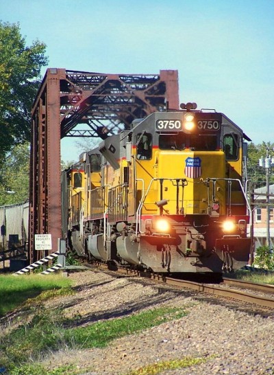Coming across the 1903 Black River Bridge and nearing the B Street Crossing was UP Train GSNARR 07 led by SD40-2 UP 3750 leading with UP 8048 SD9043AC and UP 9283 C40-8 trailing with the Old MP Depot in the background.