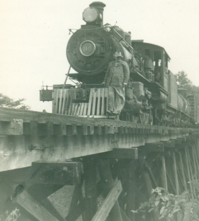 Conductor Linebarger riding across Boyds Creek trestle