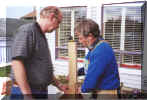 Tom Regelein assists Bill Weed in placing legs on the benchwork.