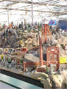 A closeup of the fire tower and power plant on  the Garden Factory train display