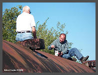 (c)2008 Robert Snyder - Bob R. and Jim S. apply a thick coat roofing paint to the baggage car. (10K) - CLICK to Enlarge (80K)