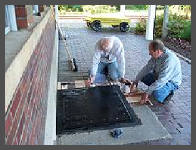 (c)2008 Robert Snyder - Bob and Jim apply a new coat of paint to the coal chute doors outside of the baggage room. (10K)