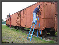 (c)2008 Robert Snyder - Bob R. replaces an access panel on boxcar #277719. (10K) - CLICK to Enlarge (100K)