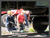(c)2006 Robert Snyder - Al O. and a Winter's crew member watch as the car is lowered back onto the wheel bearing. (10K) - CLICK to Enlarge (60K)