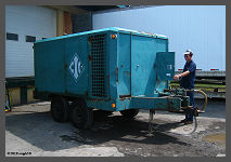 Geroge S. inspects International Chimney's 600cfm Compressor. ©smph - Click to Enlarge (10K)-(100K)
